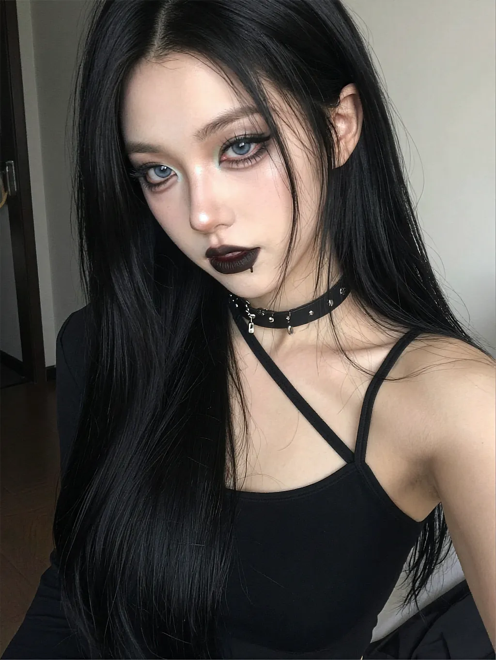 Fictional adult AI character with straight black hair and a spiked choker in a static frame