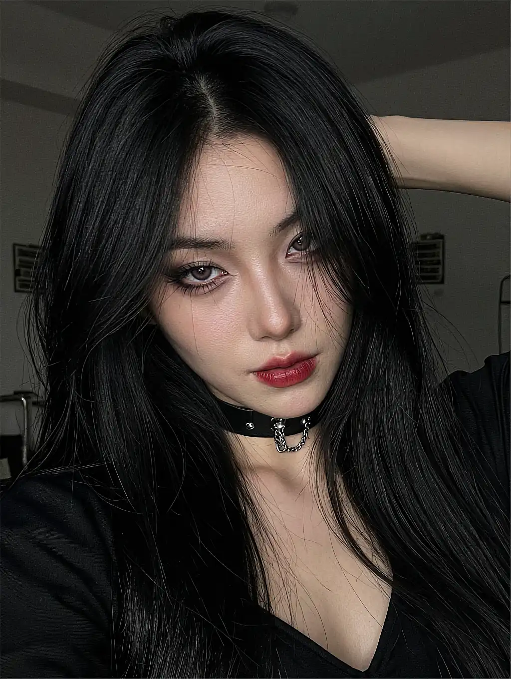 Fictional AI character with long black hair and a chain choker in flat daylight